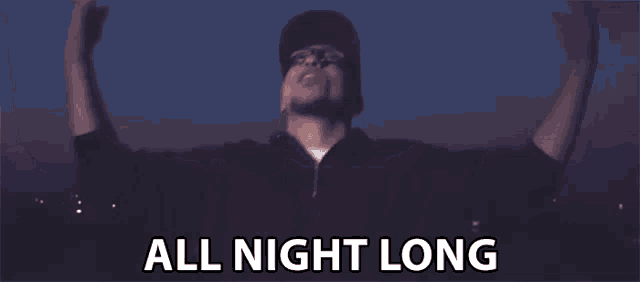 a man with glasses and a hat is standing with his arms outstretched and says `` all night long '' .
