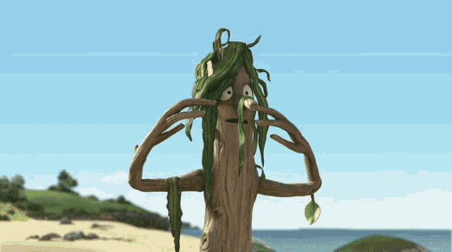 a cartoon tree with green leaves on it covering its face