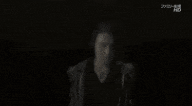 a black and white photo of a woman looking up at a light that says hd on the bottom right