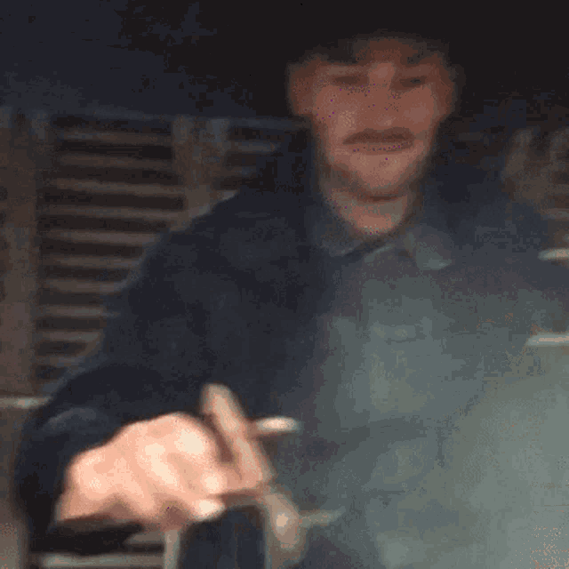a man in a cowboy hat is holding a pink object with the words eddo zegt above it