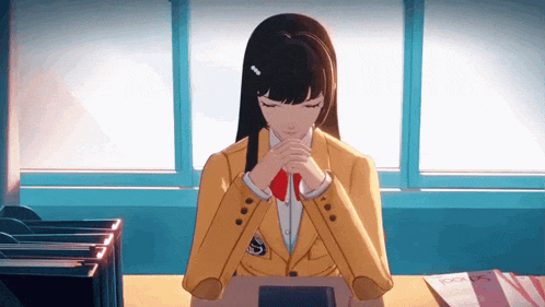 a girl sitting at a desk with her eyes closed