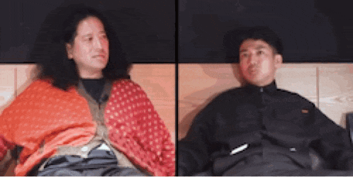 a man and a woman are sitting next to each other .