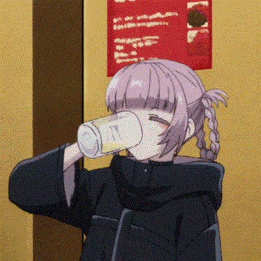 a girl is drinking from a can with the letter n on it