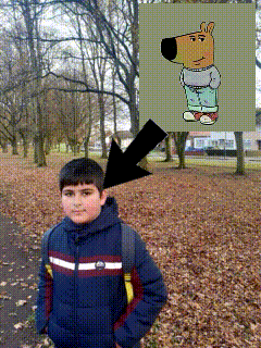 a boy in a park with an arrow pointing to a picture of a cartoon dog