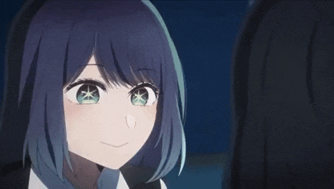 a close up of a girl with blue hair and green eyes smiling at another girl .