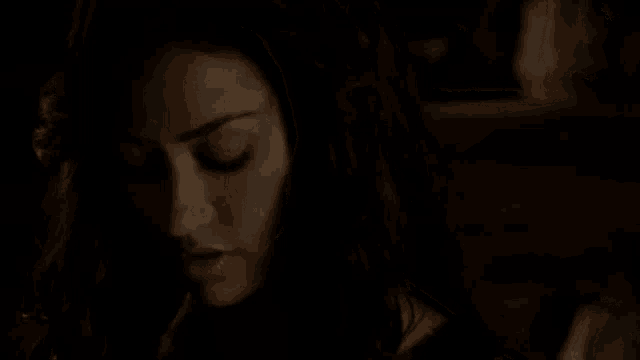 a close up of a woman 's face in the dark .