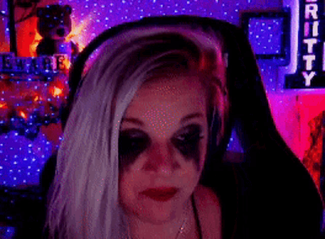 a woman with white hair and black eyes is sitting in front of a sign that says utility