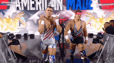two wrestlers are walking on a stage with the words american male behind them