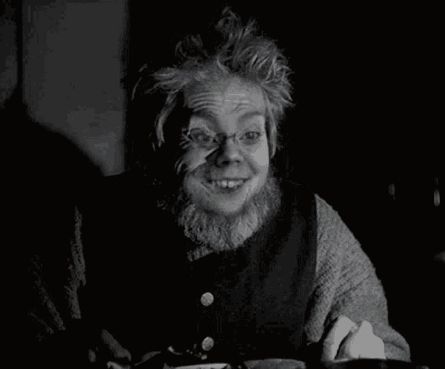 a black and white photo of a man with a beard and glasses