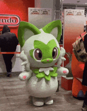 a mascot standing in front of a nintendo store