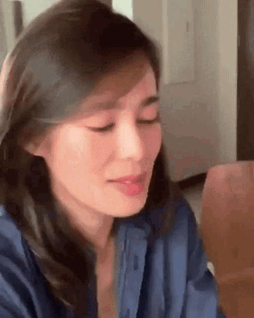 a close up of a woman 's face with her eyes closed and her mouth open .