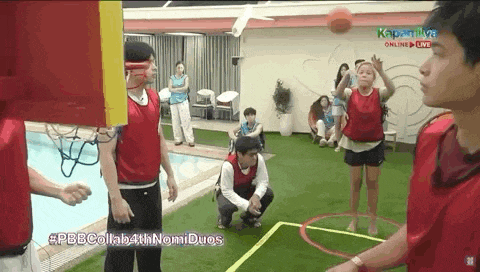 a group of people are playing a game of basketball on a basketball court .