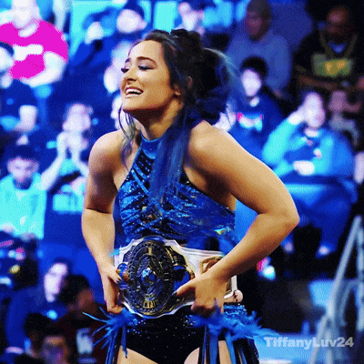 a woman in a blue dress is smiling and holding a belt that says tiffanyluv24 on it