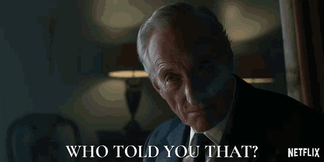 a man in a suit and tie asks who told you that
