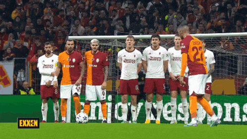 a group of soccer players standing in front of a banner that says exxon
