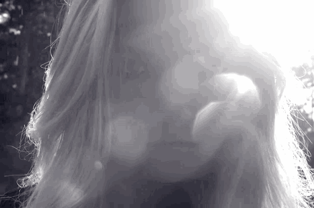 a woman 's face is shown in a black and white photo