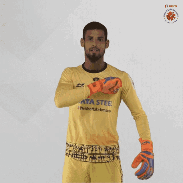 a man wearing a yellow tata steel jersey