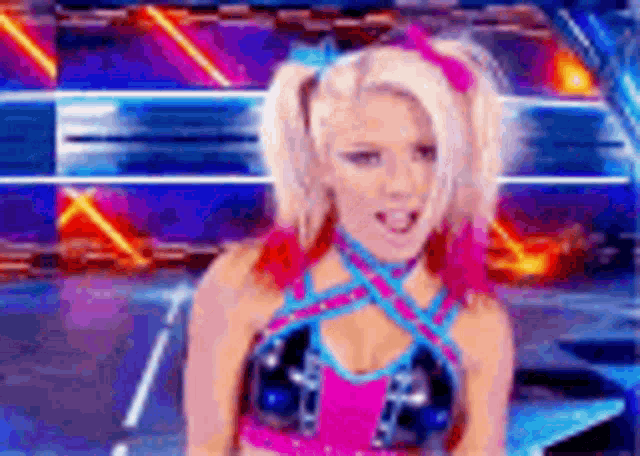 a woman with blonde hair and pink pigtails is wearing a pink and blue top .