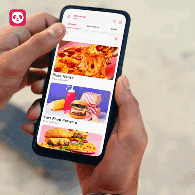 a person holding a cell phone with a pizza house app open
