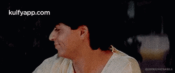 a man is laying on a bed with his head on a woman 's lap .