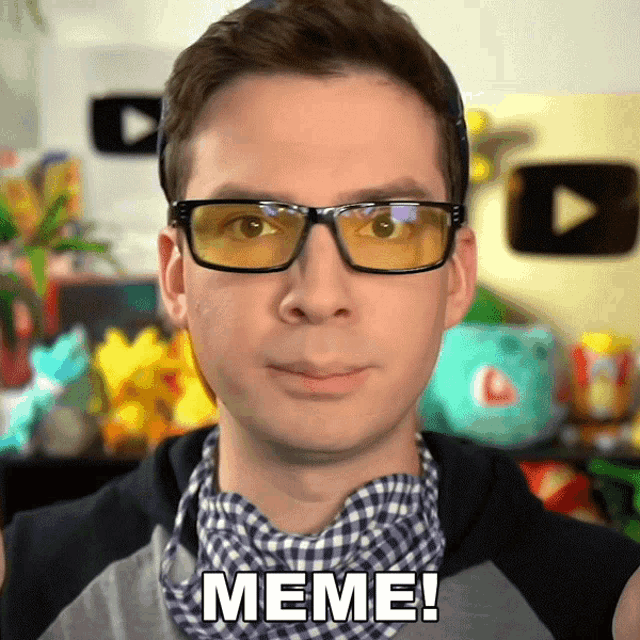 a man wearing glasses and a plaid shirt has meme written on his face