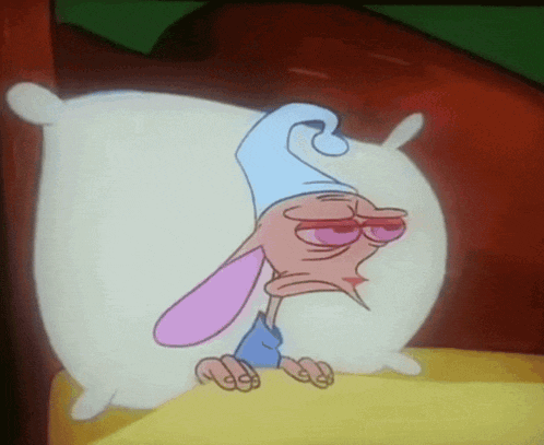 a cartoon character is laying on a white pillow