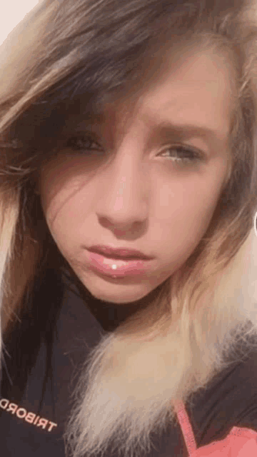 a close up of a girl 's face with a shirt that says " яовiят "