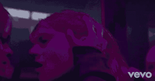 a couple of people are kissing each other in a dark room .