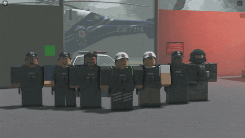 a group of police officers are standing in front of a helicopter that says em-7116 on it