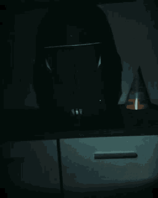 a party hat sits on a counter in the dark