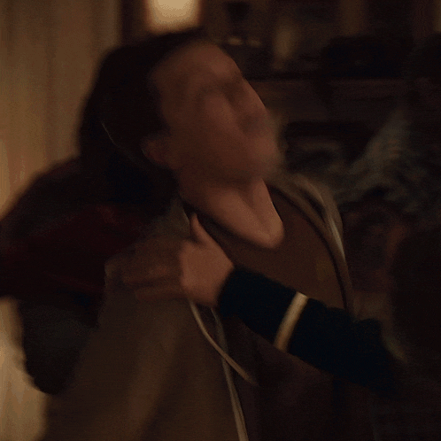 a blurry picture of a man 's neck and shoulder
