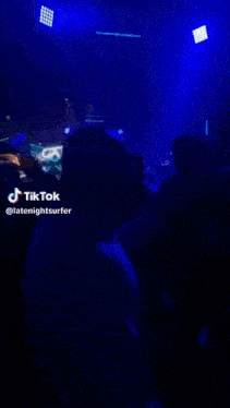 a man is dancing in a crowd with a tiktok watermark
