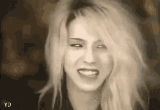 a black and white photo of a woman with blonde hair smiling .