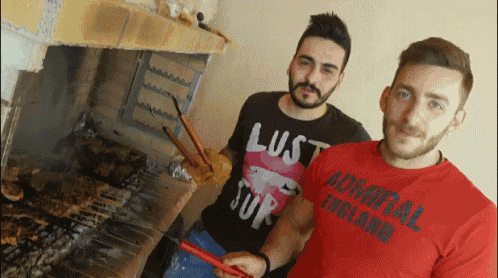 a man wearing a red admiral england shirt is cooking