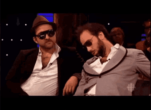 two men are sitting next to each other with the words zzzzzzzzzzzz written on the bottom
