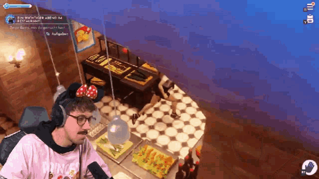 a man wearing a pink shirt with the word princess on it is playing a video game