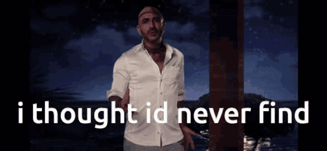 a man in a white shirt is standing in front of a sign that says " i thought id never find "