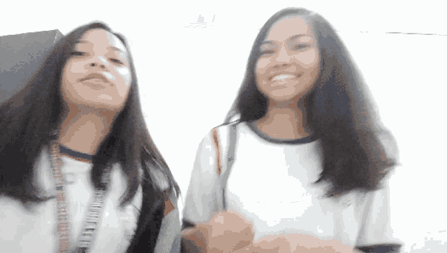 two girls are standing next to each other and one has a lanyard around her neck that says ' philippines city '