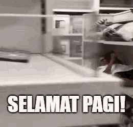 a person is standing in a closet with the words selamat pagi written on it .