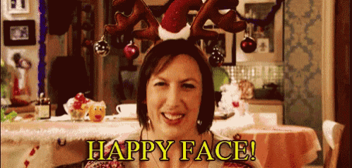 a woman wearing a reindeer headband with the words happy face written on it