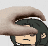 a hand is touching a cartoon character 's face with a sad look on his face