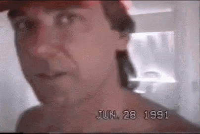 a close up of a man 's face with the date june 28 1991 written on it .