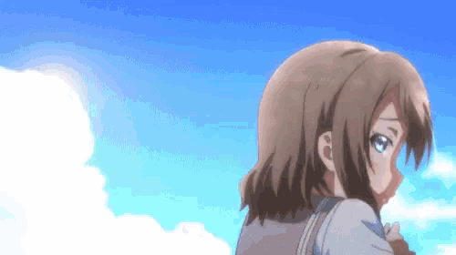 a girl with short hair is standing in front of a blue sky .