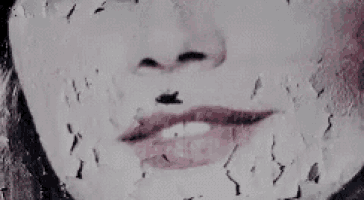 a close up of a woman 's face with a lot of spots on it