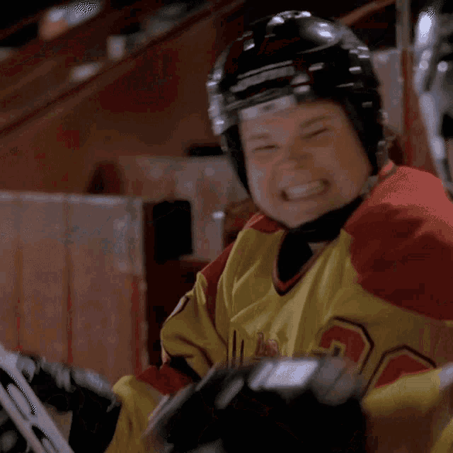 a hockey player in a yellow jersey with the number 80 on it