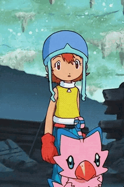 a girl in a yellow shirt is holding a pink bird in her arms .