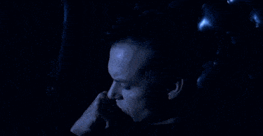 a close up of a man 's face with a blue background