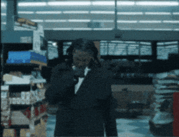 a man in a suit is walking through a store with a sign that says 10000 on it