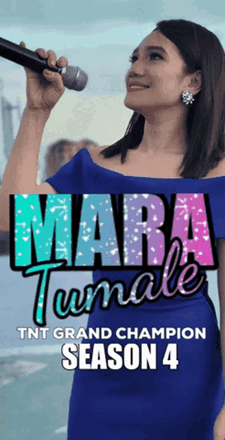 a woman in a blue dress is singing into a microphone with the words mara tumale tnt grand champion season 4