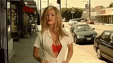 a woman in a nurse 's uniform is walking down a sidewalk in front of a book store